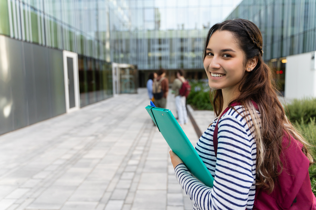 Young Hispanic University Student Woman Going To Classes At University Campus